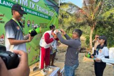 Kapolres Malang AKBP Danang Setiyo P. S., saat mengalungkan medali kepada pemenang di cabor selancar ombak Porprov Jawa Timur IX Tahun 2025, (21/6/2025) (Dok. Humas Polres Malang)