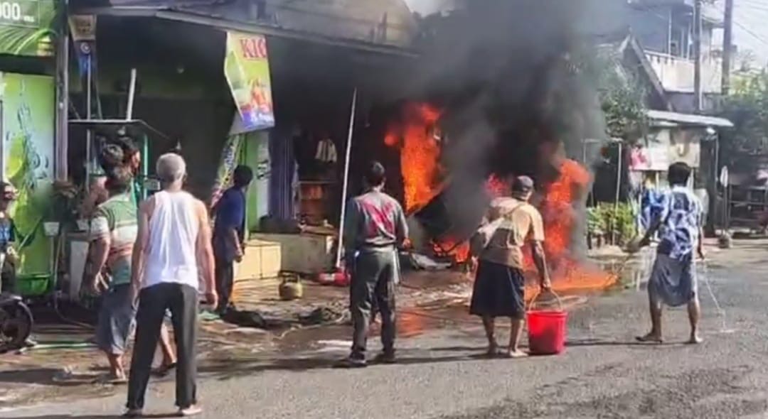 Warga berusaha memadamkan api yang membakar toko madura di Sumobito, Jombang dengan menggunakan alat seadanya (Istimewa/ Tagarjatim.id)