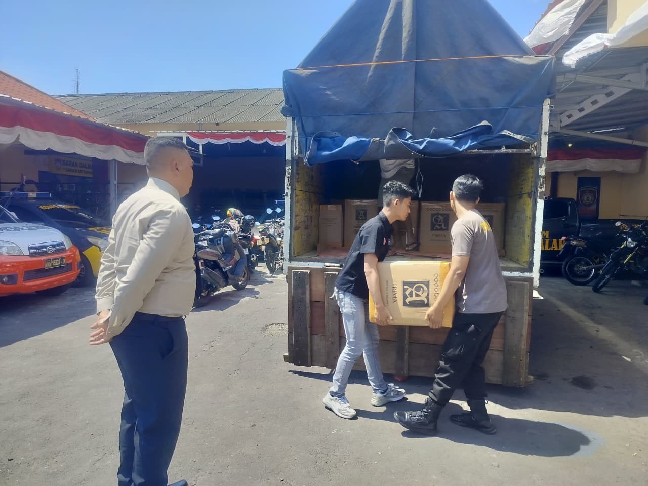 Polisi saat membongkar kontainer berisi ribuan arak Bali siap edar secara ilegal. (Istimewa)