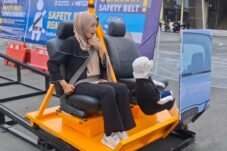 Pemohon SIM di Satlantas Polres Blitar mencoba alat peraga sabuk keselamatan, untuk mengingatkan pentingnya tertib lalu lintas, agar tidak terjadi efek fatal saat berkendara seperti boneka yang terlempar disebelahnya (Novianto, tagarjatim.id)